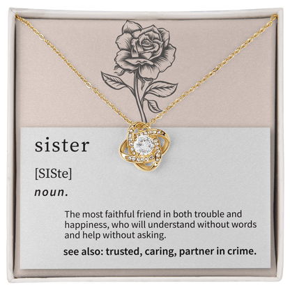 close up of a delicate love knot pendant chosen as a meaningful gift for a sister