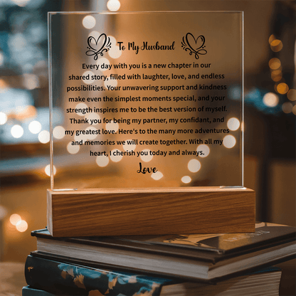 husband holding a beautifully engraved acrylic plaque in a joyful moment