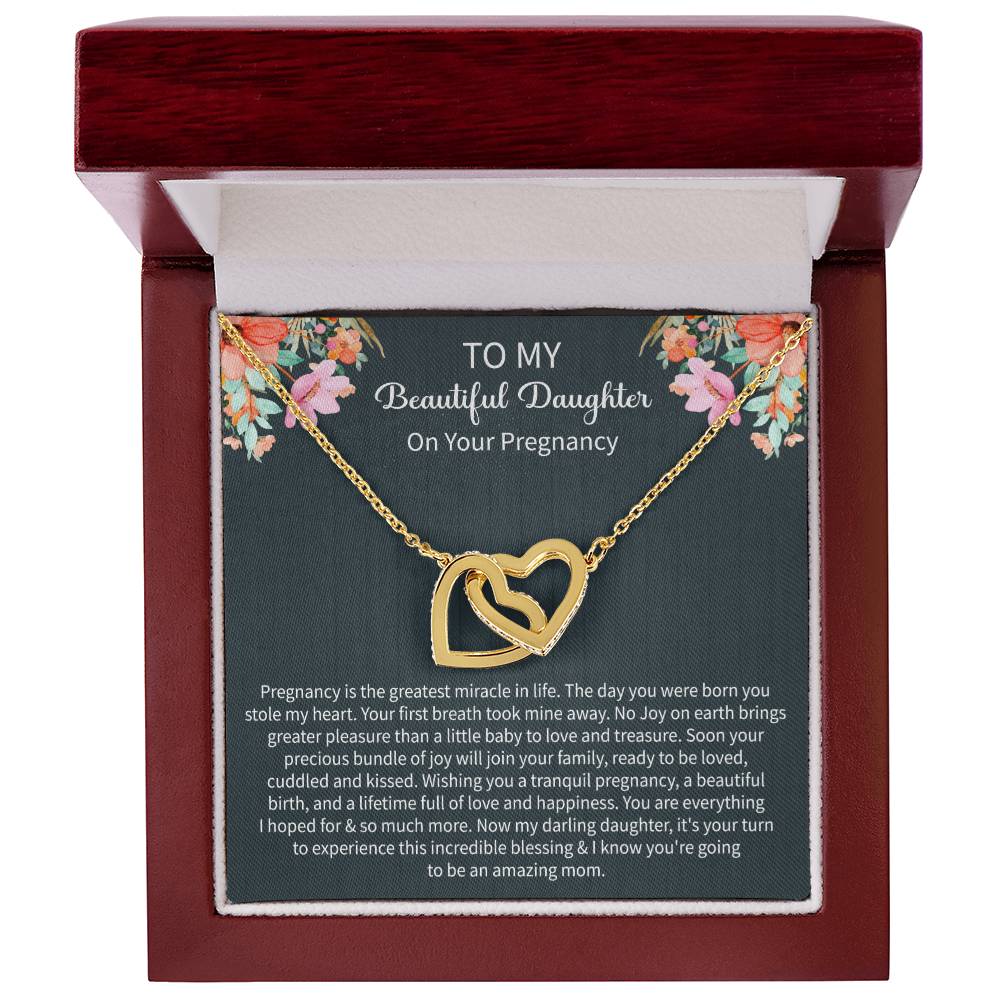emotional gifting moment featuring a Giftsignature necklace given to a pregnant daughter