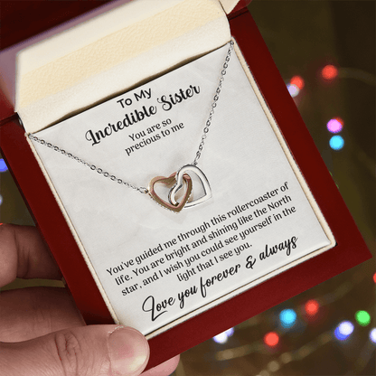 interlocking hearts necklace displayed with a heartfelt message card for sister